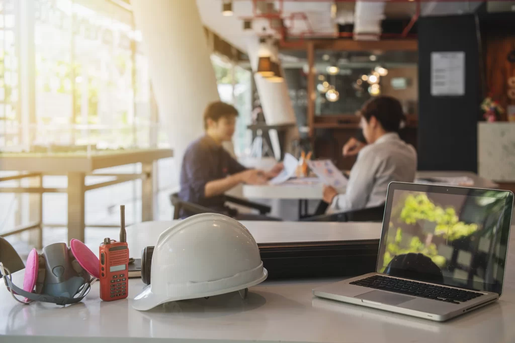 Hard hat and laptop on top of a table